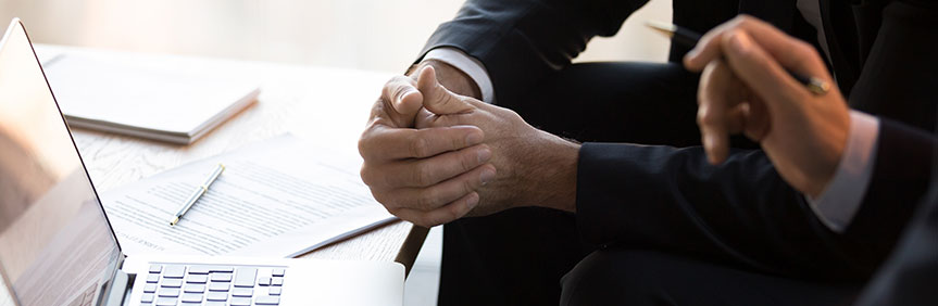 two business men in front of laptop